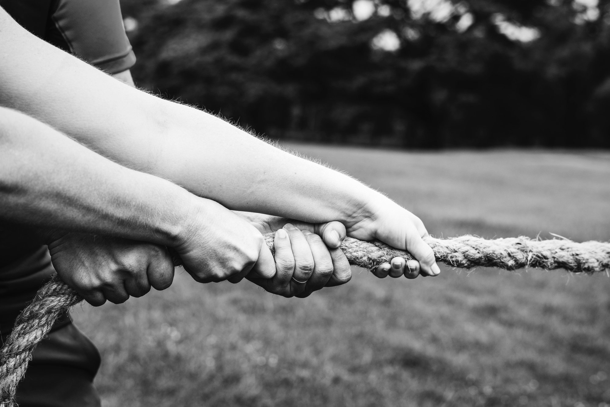 hands pulling a rope in a tug of war